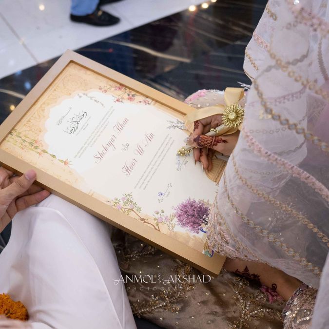 Bride Signing Nikkah Frame at her Wedding