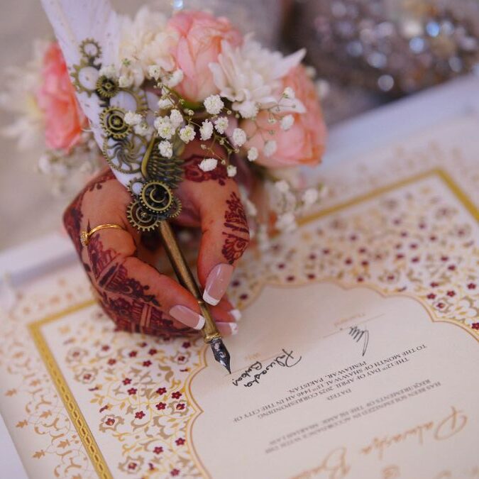 A girl signing a nikkah nama by the framers